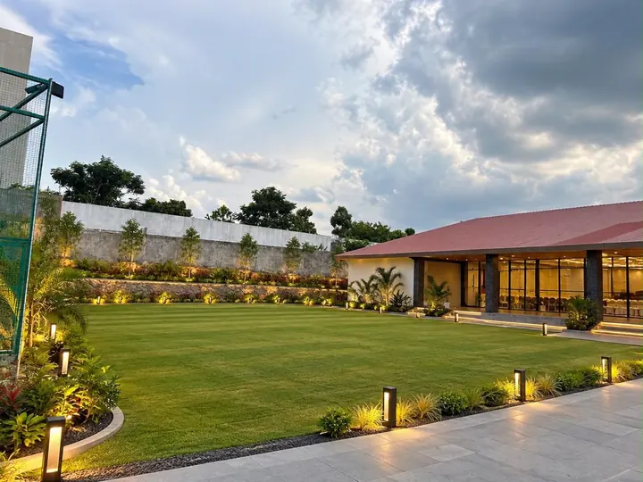 Green lawn beside a banquet hall on a bright day